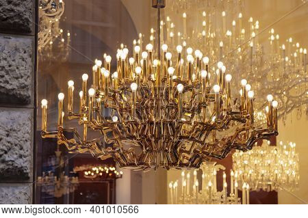 Expensive Luxury Large Chandelier Behind Glass With Gilding. Reflection In The Shop Window. Lights I