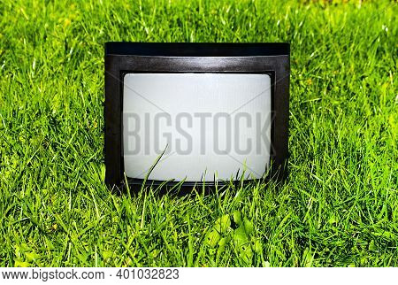 Old Analog Television Set On The Grass Outdoor