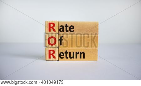 Ror - Rate Of Return Symbol. Concept Word 'ror - Rate Of Return' On Wooden Cubes And Blocks On A Bea