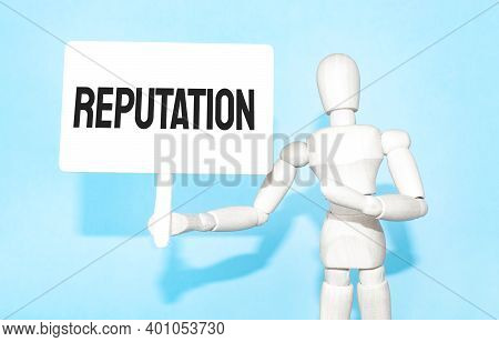 The Wooden Man Holds A White Sign With The Text Reputation In His Hands. The Content Of The Letterin