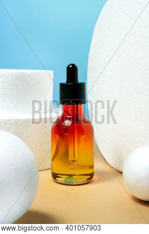 Glass Bottle With Pipette Essential Oil, Serum On Blue And Bige Background. Face, Skin Care Organic 