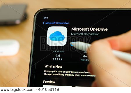 Microsoft Onedrive Logo Shown By Apple Pencil On The Ipad Pro Tablet Screen. Man Using Application O