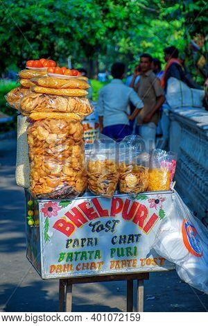 Papri Chat, Bhel Puri And Wide Variety Of Chats Being Sold By A Fast Food Vendor In His Cart Beside