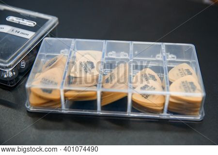 Zaporozhye, Ukraine - 14.03.2020 Yellow Picks For Playing Guitar Are In A Transparent Container.