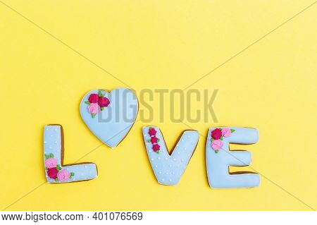 Inscription Love By Homemade Cookies On Yellow Background With Copy Space. Holiday Concept For Weddi