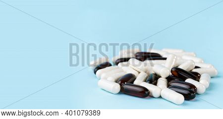 Pharmaceutical Pills And Vitamins. Medicine Or Supplement Capsules On Blue Surface. Probiotic, Inuli
