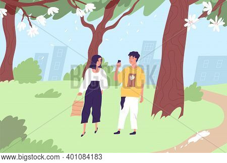 Happy Couple Walking In Green City Park In Summer. Modern People Strolling In Nature. Young Guy Taki
