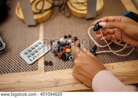 Woman choosing ear pads in audio store