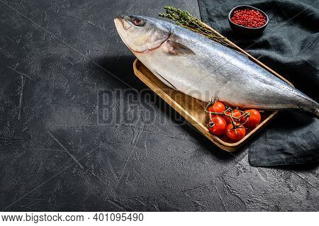 Fresh Whole Japanese Amberjack. Raw Fish Yellowtail. Black Background. Top View. Copy Space