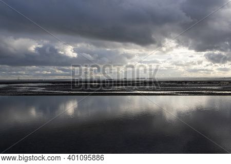 Reflections On Chalkwell Beach, Near Southend-on-sea, Essex, England