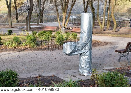 Plants And Trees In A Park Or Garden Covered With Blanket, Swath Of Burlap, Frost Protection Bags Or