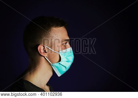 Caucasian Sick Man In A Medical Gause Mask With Palm On His Head.