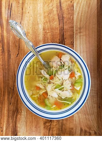 A Bowl Of Chicken Soup With Dumplings