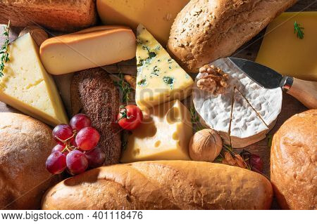 Cheese And Bread Background. Many Types Of Bread And Cheese. Cheese Platter, Tasting And Pairing. An