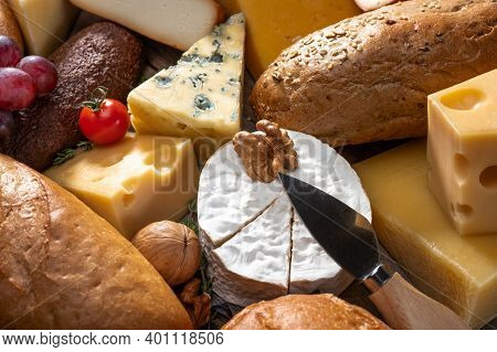 Cheese And Bread Background. Many Types Of Bread And Cheese. Cheese Platter, Tasting Assortment Of V