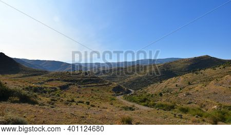 Dirt Track In The Las Bargas Ravine. Blue Sky And Sun Appearing On The Left.