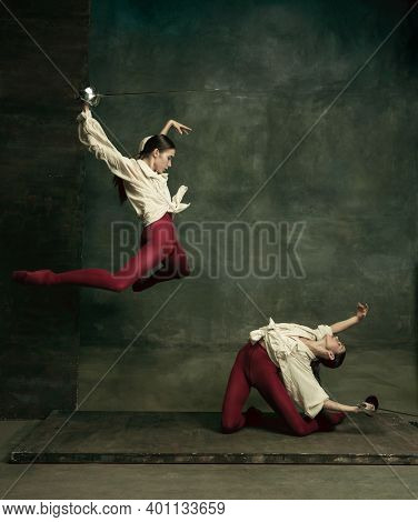 Attacking. Two Young Female Ballet Dancers Like Duelists With Swords On Dark Green Background. Cauca