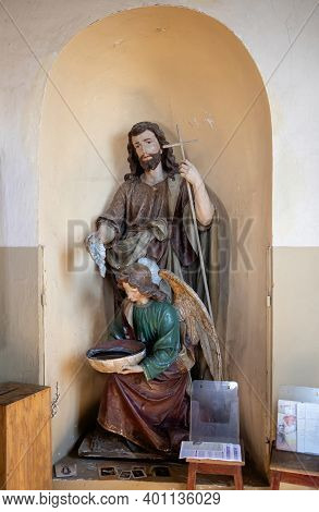 Suderve, Lithuania - April 2, 2017: Statue Of John The Baptist And A Holy Water Container (stoup) On
