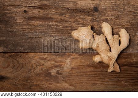 Close Up Of Fresh Ginger Root On Wooden Table