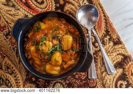 Hungarian Chicken Paprikash With Gnocchi Potato Dumplings And Parsley Garnish