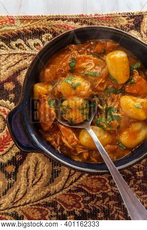 Hungarian Chicken Paprikash With Gnocchi Potato Dumplings And Parsley Garnish