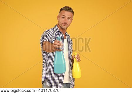 Make Your House Clean. Handsome Guy Hold Spray Bottles. Disinfectant Cleaners And Sprays. Clean Habi