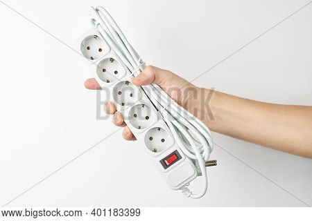 Person Holds Empty White Power Cord Strip. Outer Space. Isolated On White Background.