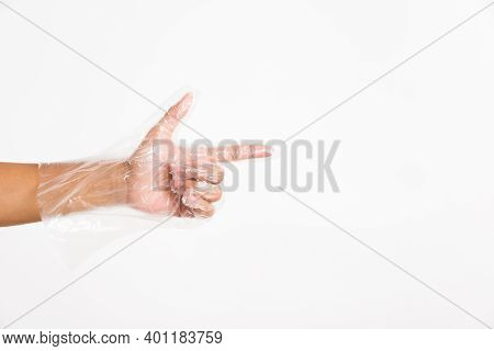 Woman Hand Wearing Single Use Protect Disposable Transparent Plastic Glove With Point Finger Sign Ge