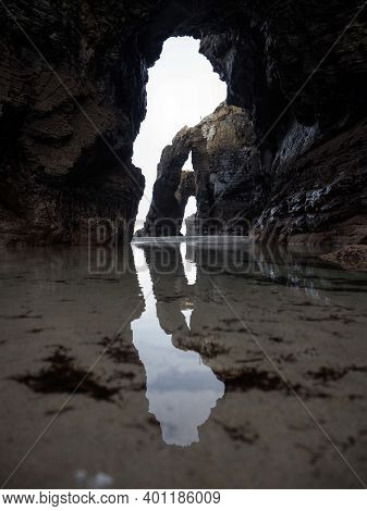 Massive Natural Arches Visible At Praia As Catedrais Cathedrals Beach Near Ribadeo Galicia In Spain 