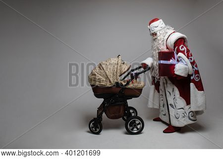 Picture Of Old Santa Claus Walks Witha Baby Stoller