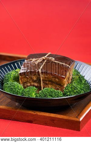 Dong Po Pork Meat In A Blue Plate With Broccoli With Red Background.
