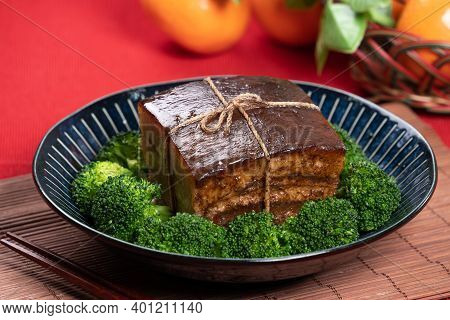 Dong Po Pork Meat In A Blue Plate With Broccoli With Red Background.