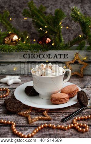 Vertical New Year Composition. Coffee With Mashmelou In A White Cup, Macarons, Brown Beads, Stars On