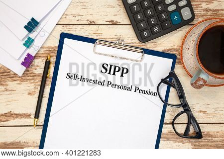 Paper With Self-invested Personal Pension Sipp On The Table, Calculator And Glasses