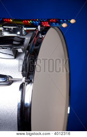 Silver Sparkel Snare Drum And Sicks Isolated On Blue