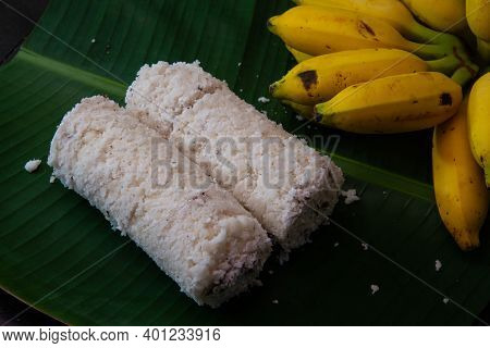 Popular Steamed Kerala Breakfast Dish Served In Banana Leaf With Yellow Banana, Puttu And Yellow Sma