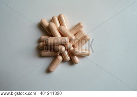 Top View Of Heap Of Pink Capsules Of Probiotic Dietary Supplements