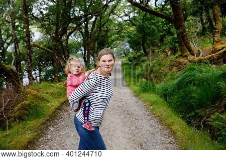 Mother Holding Little Toddler Girl In Glenveagh National Park In Ireland. Smiling And Laughing Baby 