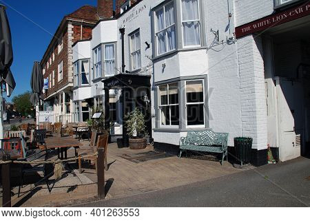 TENTERDEN, ENGLAND - MAY 31, 2020: The historic White Lion Hotel in the High Street at Tenterden in Kent. Parts of the old coaching inn date back over 400 years.