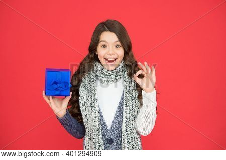 Stylish Child Girl In Casual Warm Apparel With Box After Successful Seasonal Shopping On Xmas Holida
