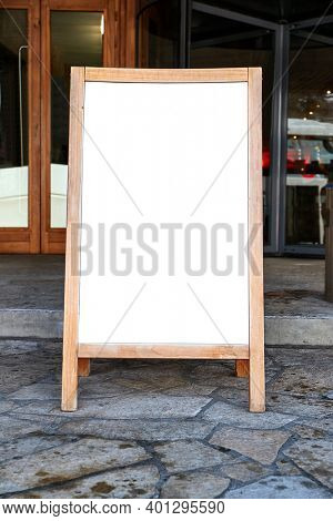 Empty menuboard on in front of a restaurant, blank white sign board, no text