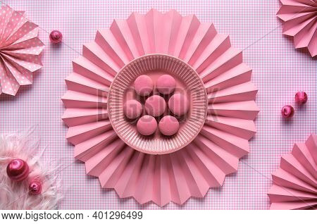 Sweet And Tasty Macaroons On A Plate. Creative Monochrome Flat Lay On Checkered Pink Paper And Folde