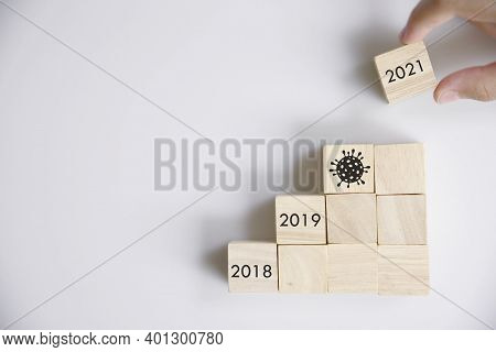 New Year 2020 (covic19) To 2021 With Hand Putting Wood Cube In Progress Bar.
