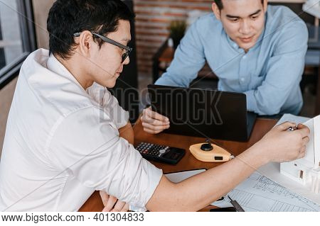 Businessman And Architech Meeting For Planing And Checking House Design And House Model And Secretar