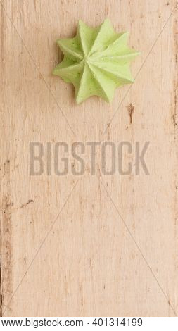 Green, Sweet, Crispy Meringue On A Wooden Background.