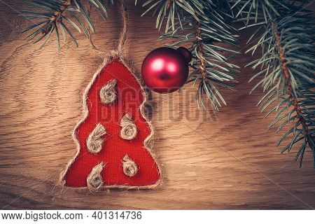 .knitted Toy And Pine Branch On Wooden Background.