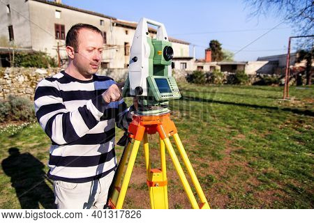 Man Using Of Total Station. Guy Surveyor At Work. Survey Instrument Geodetic Device, Total Station S
