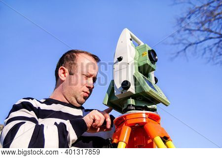 Man Using Of Total Station. Guy Surveyor At Work. Survey Instrument Geodetic Device, Total Station S