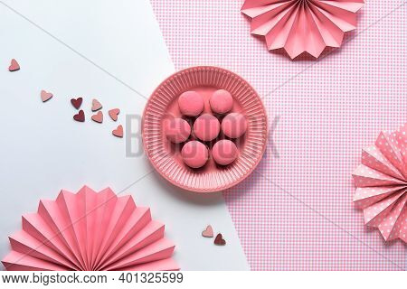 Creative Food Concept. Macaroons On A Plate. Monochrome Flat Lay On Split Two Tone Pink White Backgr