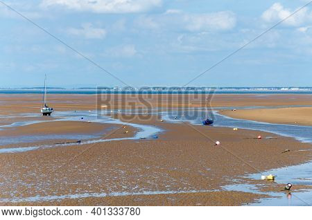Meols, The Wirral, Uk: Jun 23, 2020: Small Boats Rest On The Sand At Low Tide.